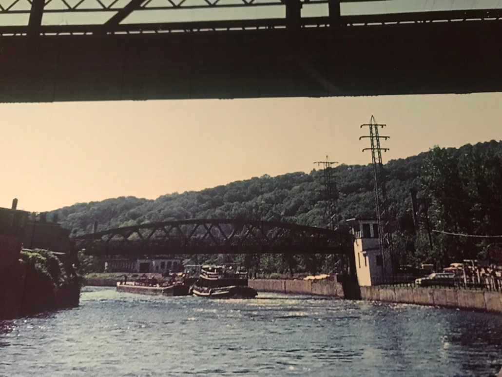 Barge passing beneath lift bridge, photo taken from under emergency bridge.