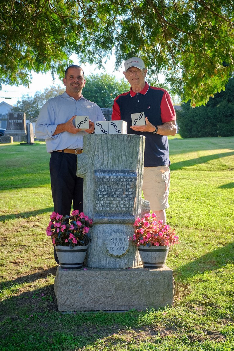 Dan Enea and Louis Baum holding Broken Chain Grave Markers [Photo by Sarah Rogers]