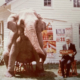 1974 Milo holding his carved “Smith Bros Circus Red Caboose” alongside Marie, his favorite elephant on the side lawn at the Smith Brothers Farm