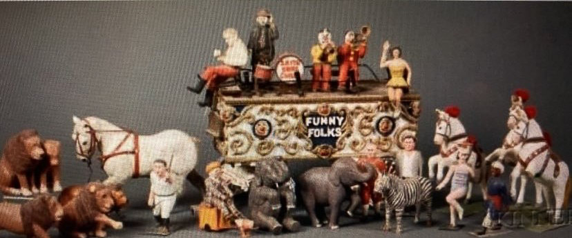 Carved figurines of the folk-art circus acts that were carved by Milo, also included is the “Funny Folk’s” circus act wagon